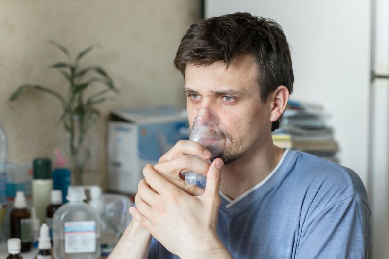 Man with nebulizer over face