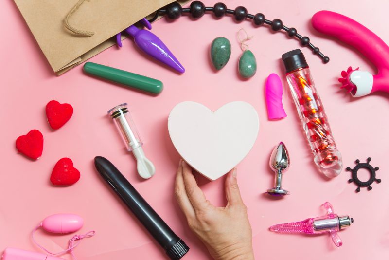 Assortment of sexual aids on pink background