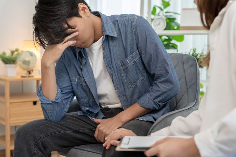 Man with scrotal pain, speaking with doctor