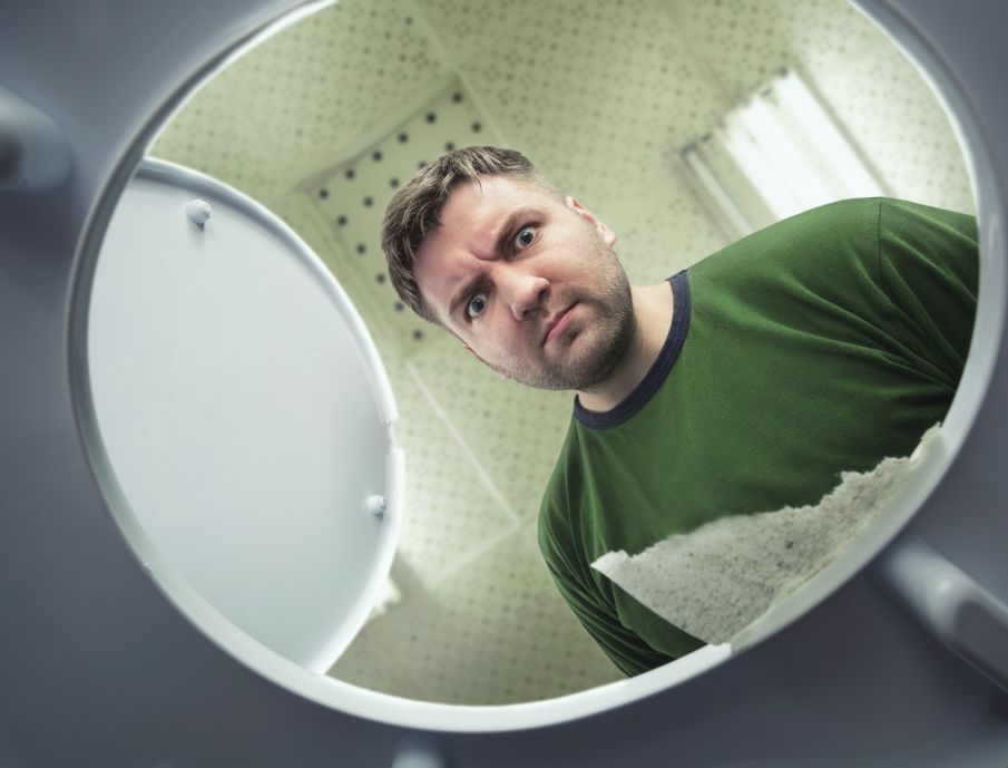 Man looking into toilet