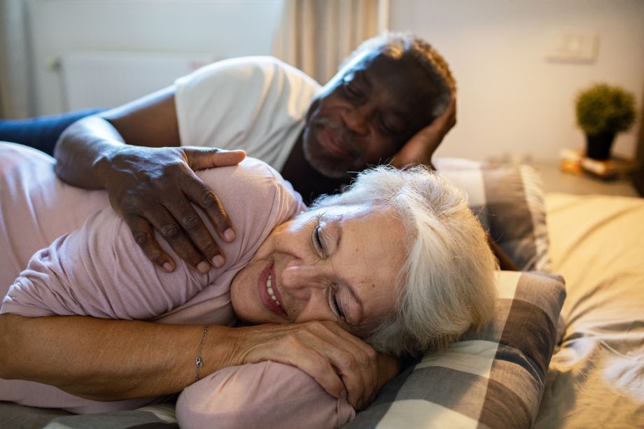 older couple snuggling in bed