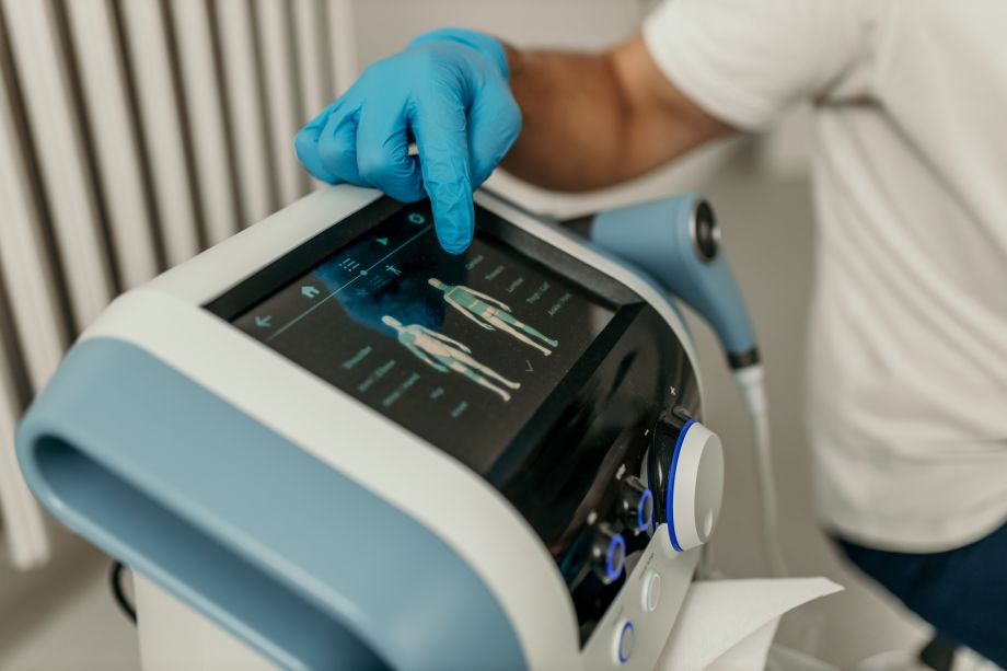 technician pointing at shockwave therapy screen