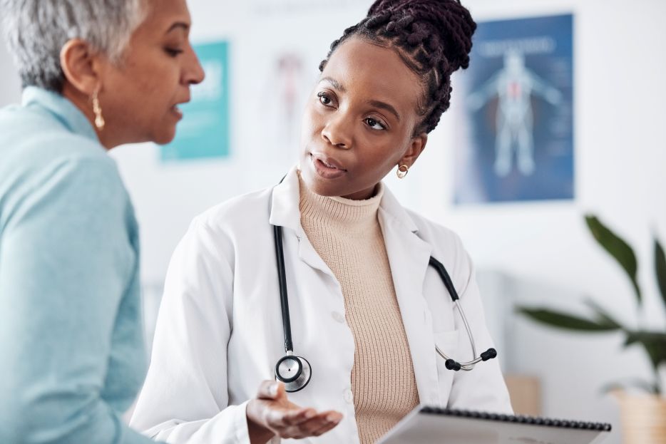 doctor speaking with older woman
